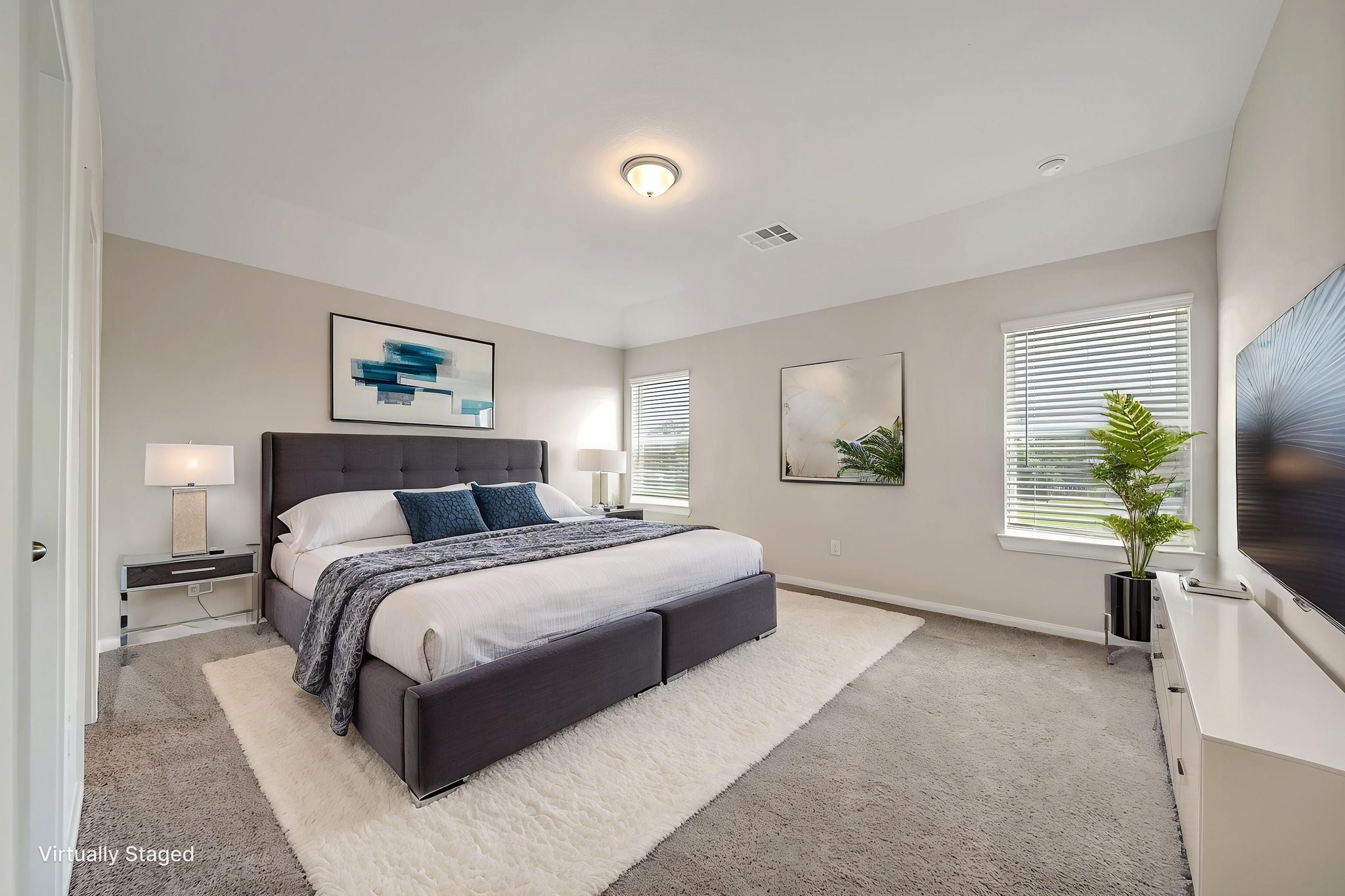 20629 Dynamic Court Humble, TX 77338 - Photo 19 of 26 a spacious bedroom with a bed and a flat screen tv