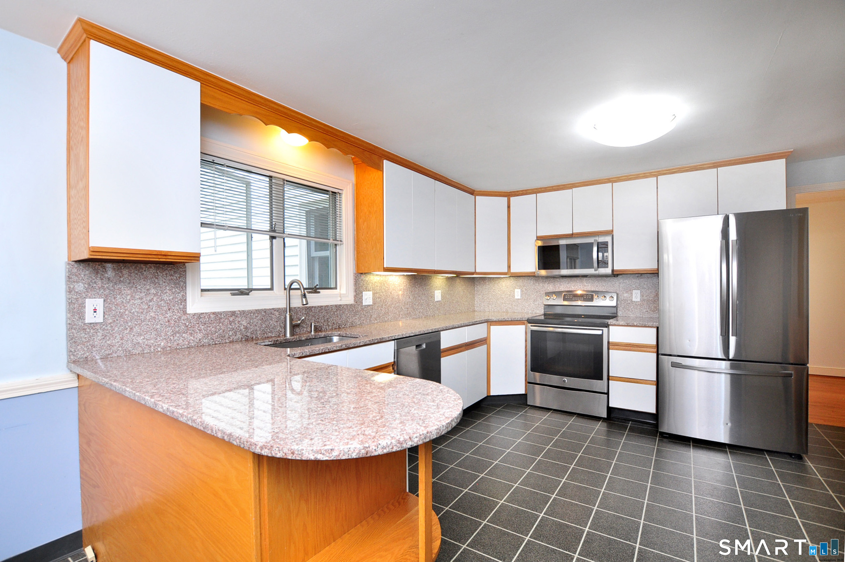 44 Miamis Road West Hartford, CT 06117 - Photo 14 of 39 a kitchen with kitchen island granite countertop a sink appliances cabinets and a counter top space