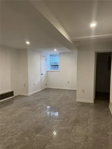 an empty room with a empty space and windows