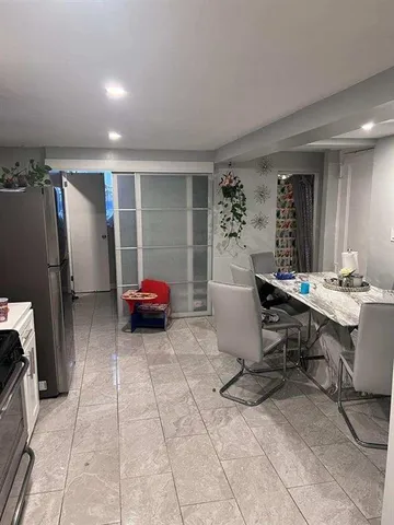 a living room with furniture a air conditioner vent and a window