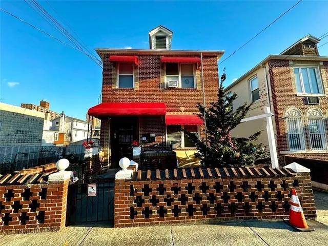 a front view of a house with wooden fence