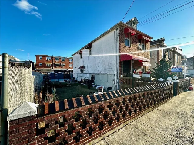 a view of a house with wooden fence
