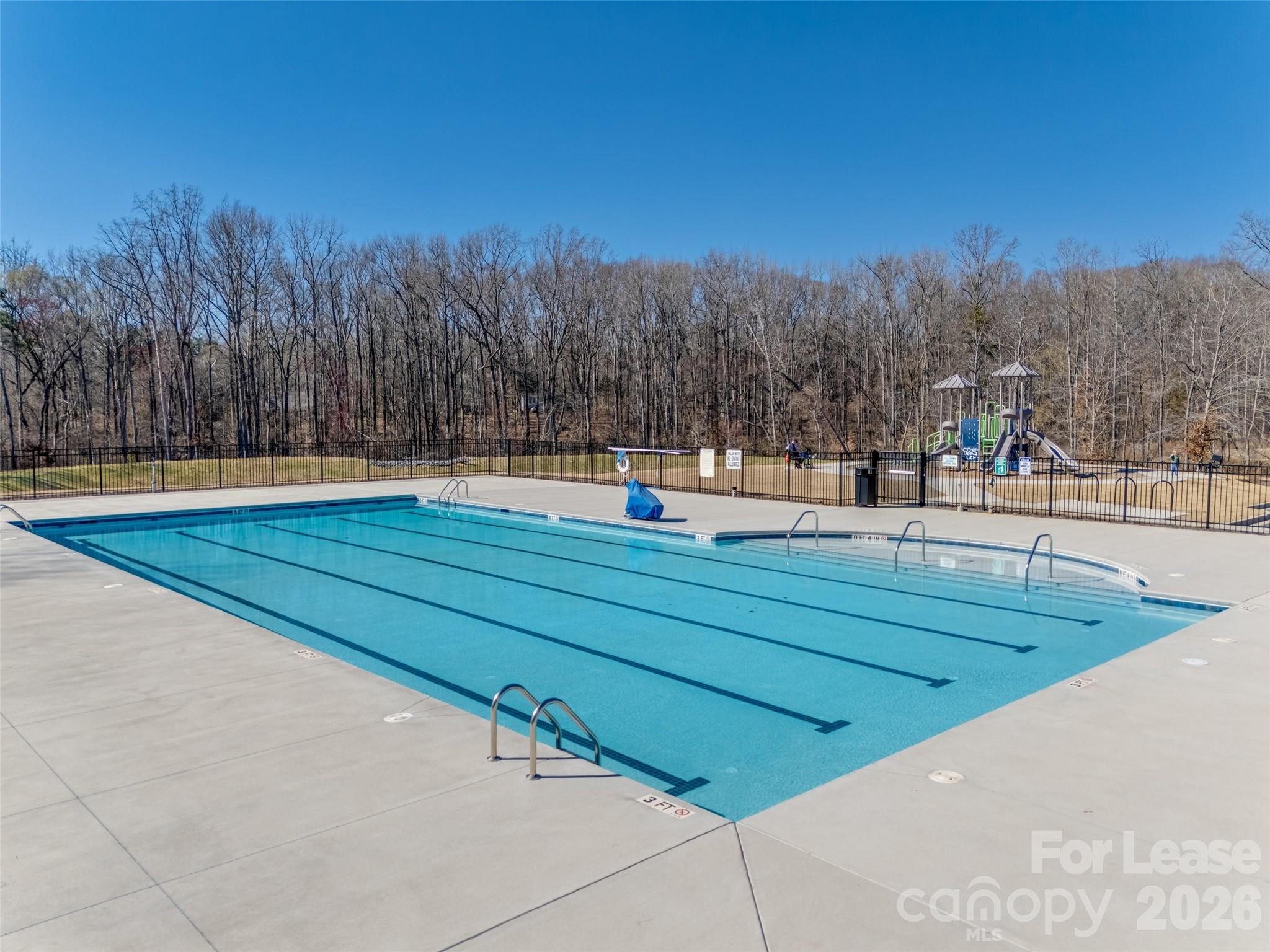 807 Gable Oak Lane Fort Mill, SC 29708 - Photo 36 of 39 a view of a swimming pool and trees in the background