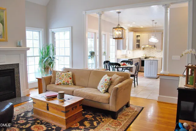 a living room with furniture a fireplace and a flat screen tv