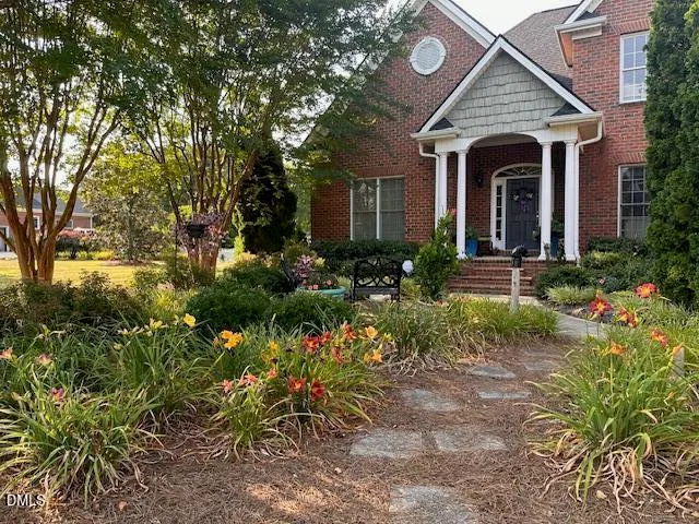 a front view of a house with garden