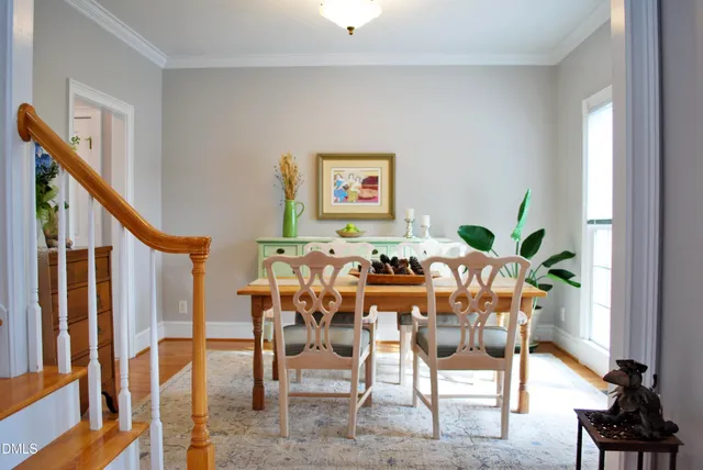 a view of a dining room with furniture and a potted plant