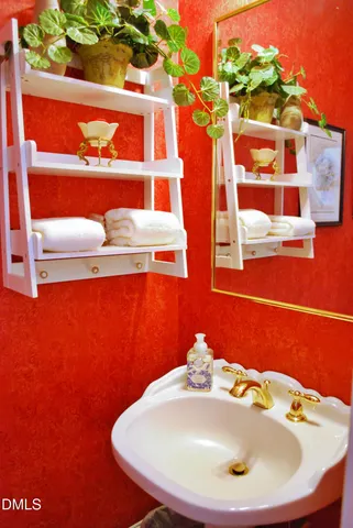 a bedroom with a bed a dresser and next to a window