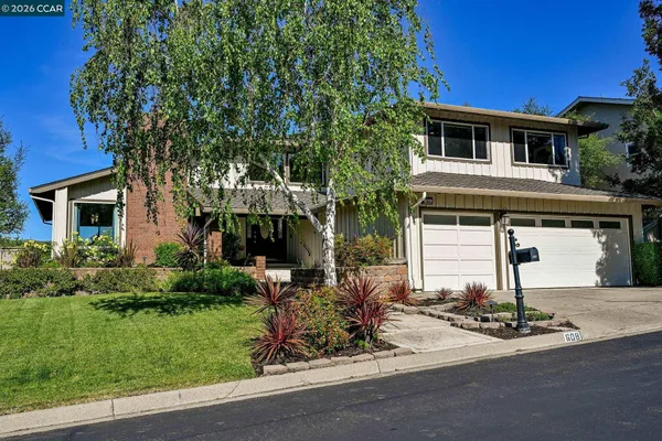 a front view of a house with garden