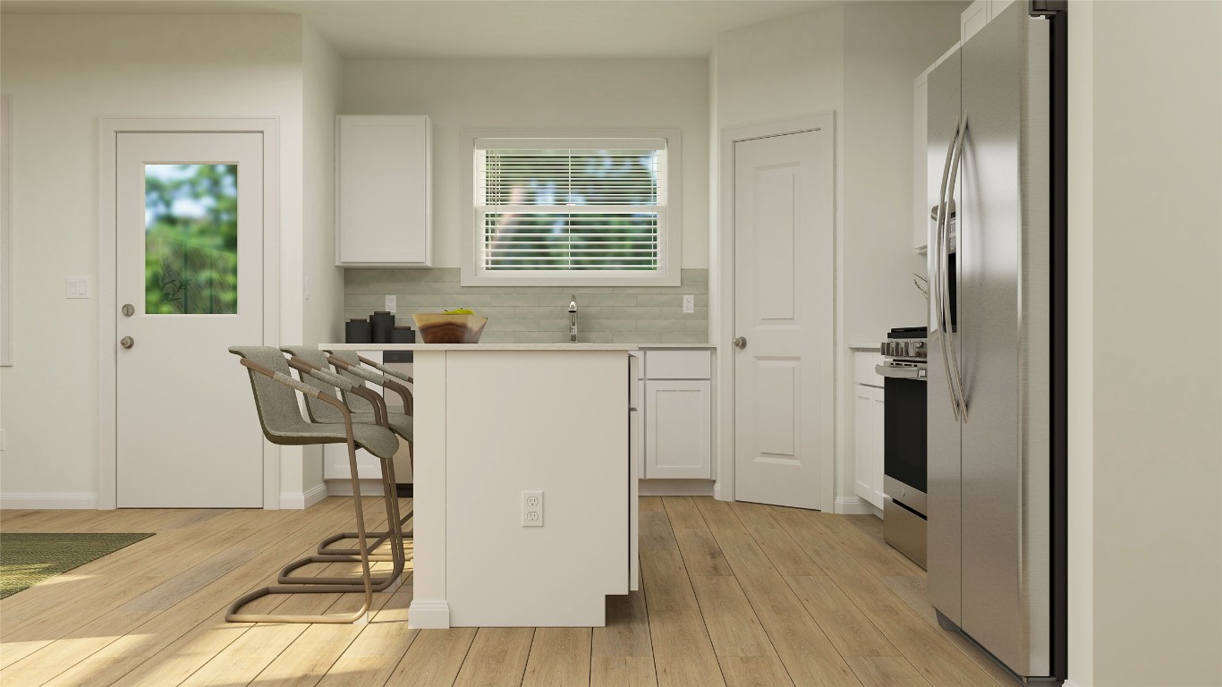 18024 Prairie Falcon Way Pflugerville, TX 78660 - Photo 17 of 23 a room with a table chairs and a refrigerator