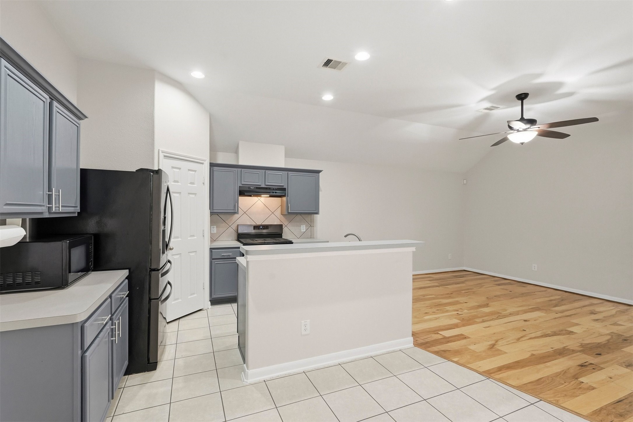 13218 South Point Lane Houston, TX 77034 - Photo 6 of 25 a kitchen with a refrigerator a stove top oven and cabinets