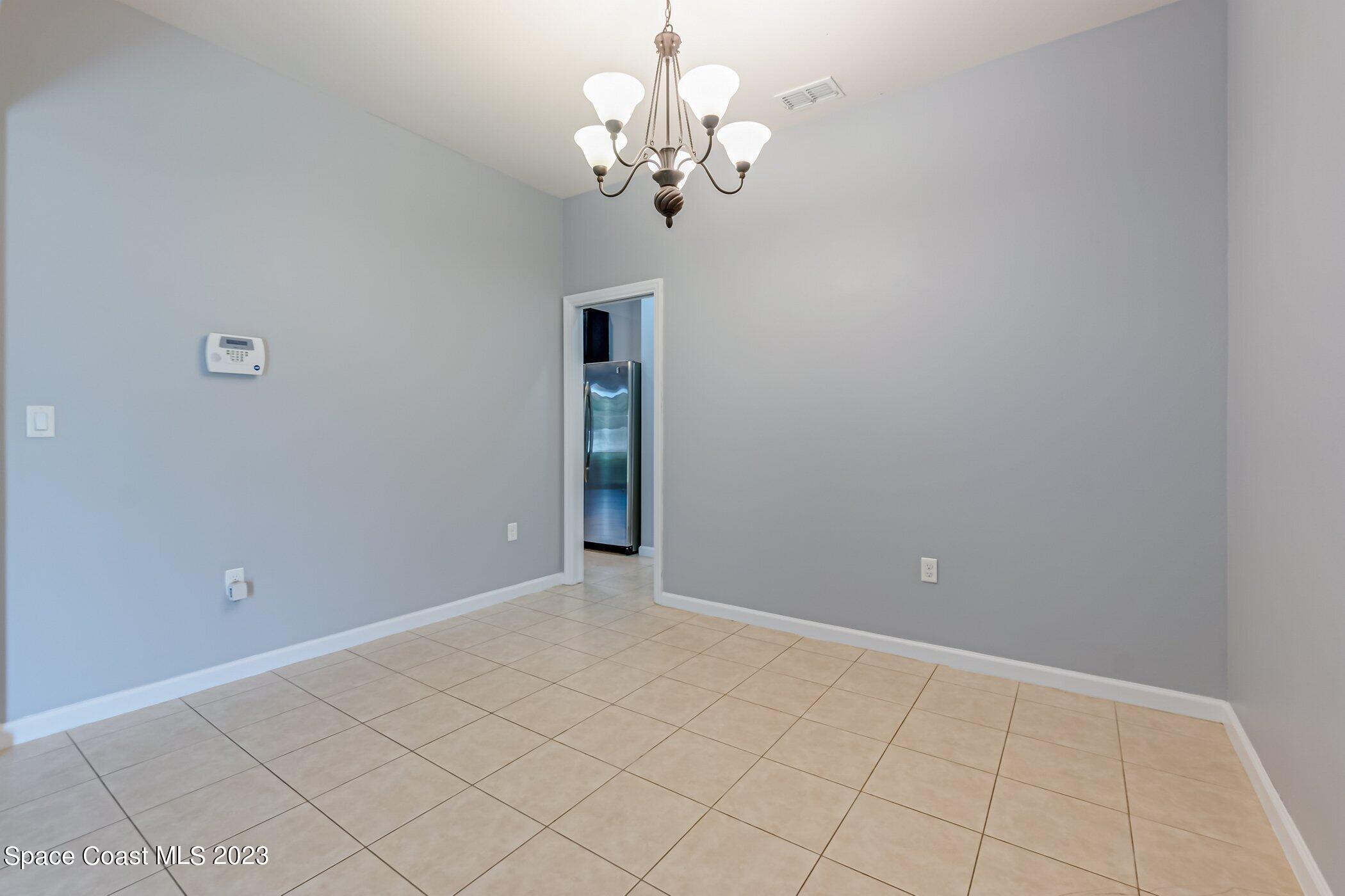 3194 Arden Circle Melbourne, FL 32934 - Photo 11 of 40 a view of a chandelier in big room and chandelier
