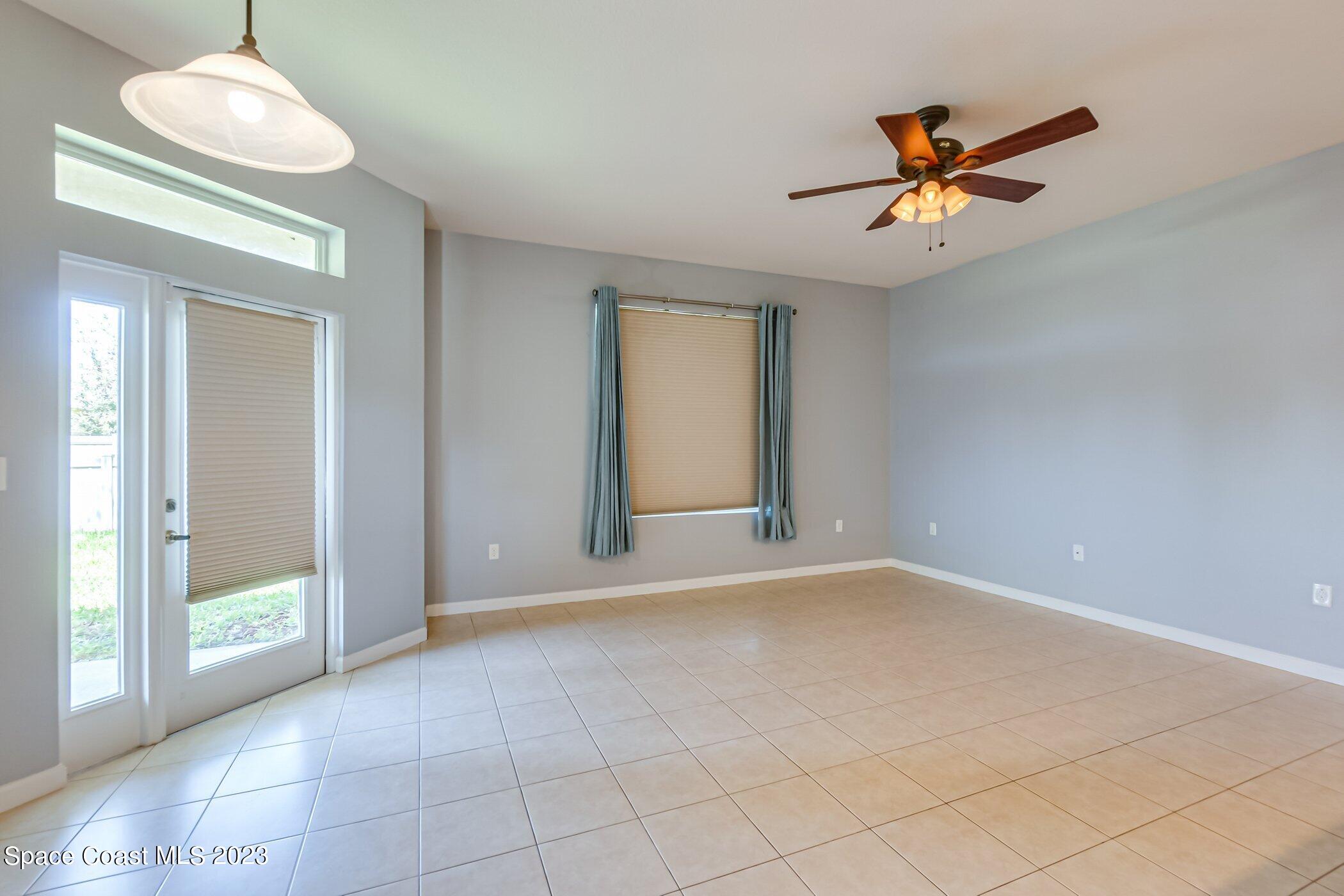 3194 Arden Circle Melbourne, FL 32934 - Photo 16 of 40 a view of a livingroom with a chandelier fan and windows