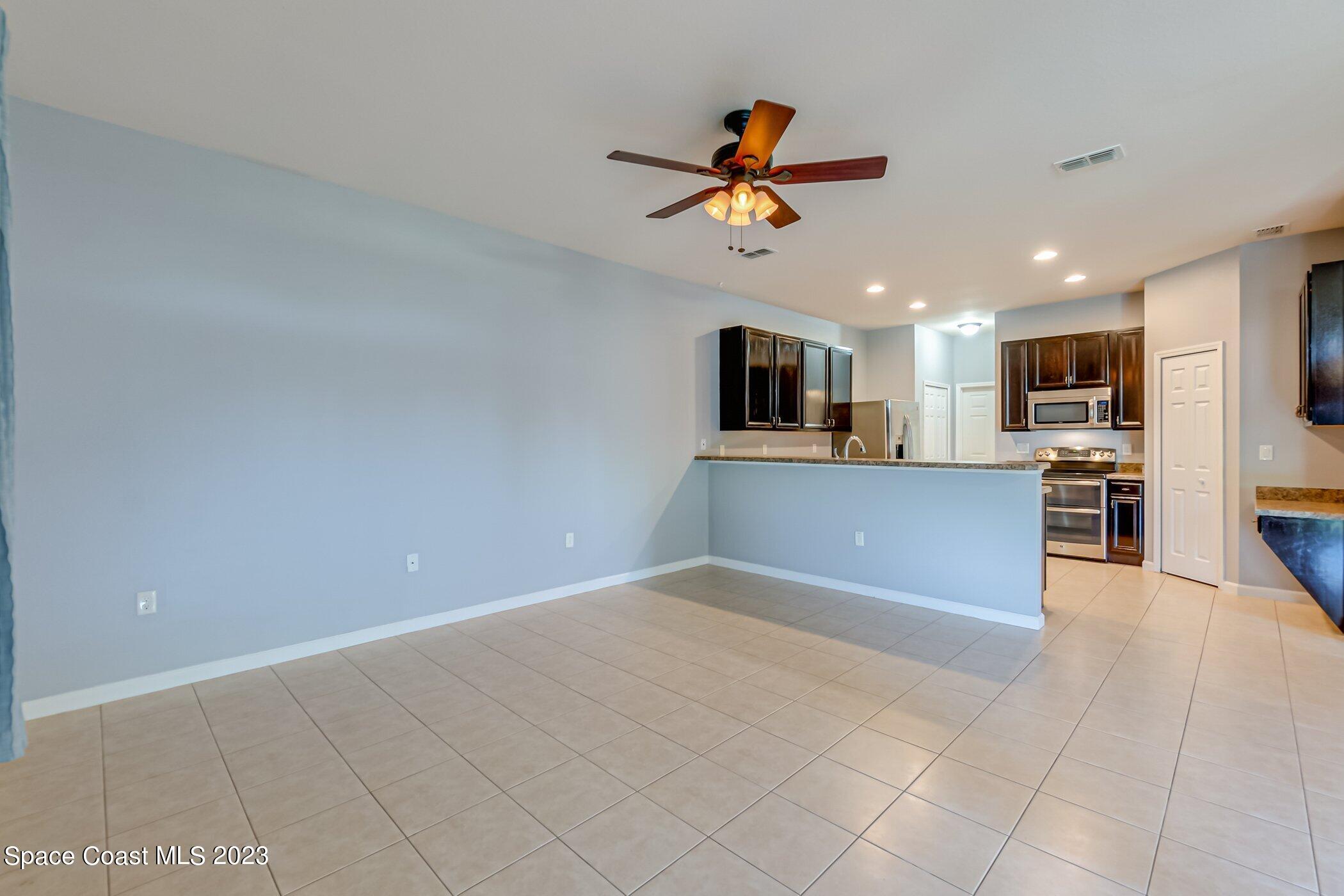 3194 Arden Circle Melbourne, FL 32934 - Photo 18 of 40 a view of a kitchen with a sink and microwave
