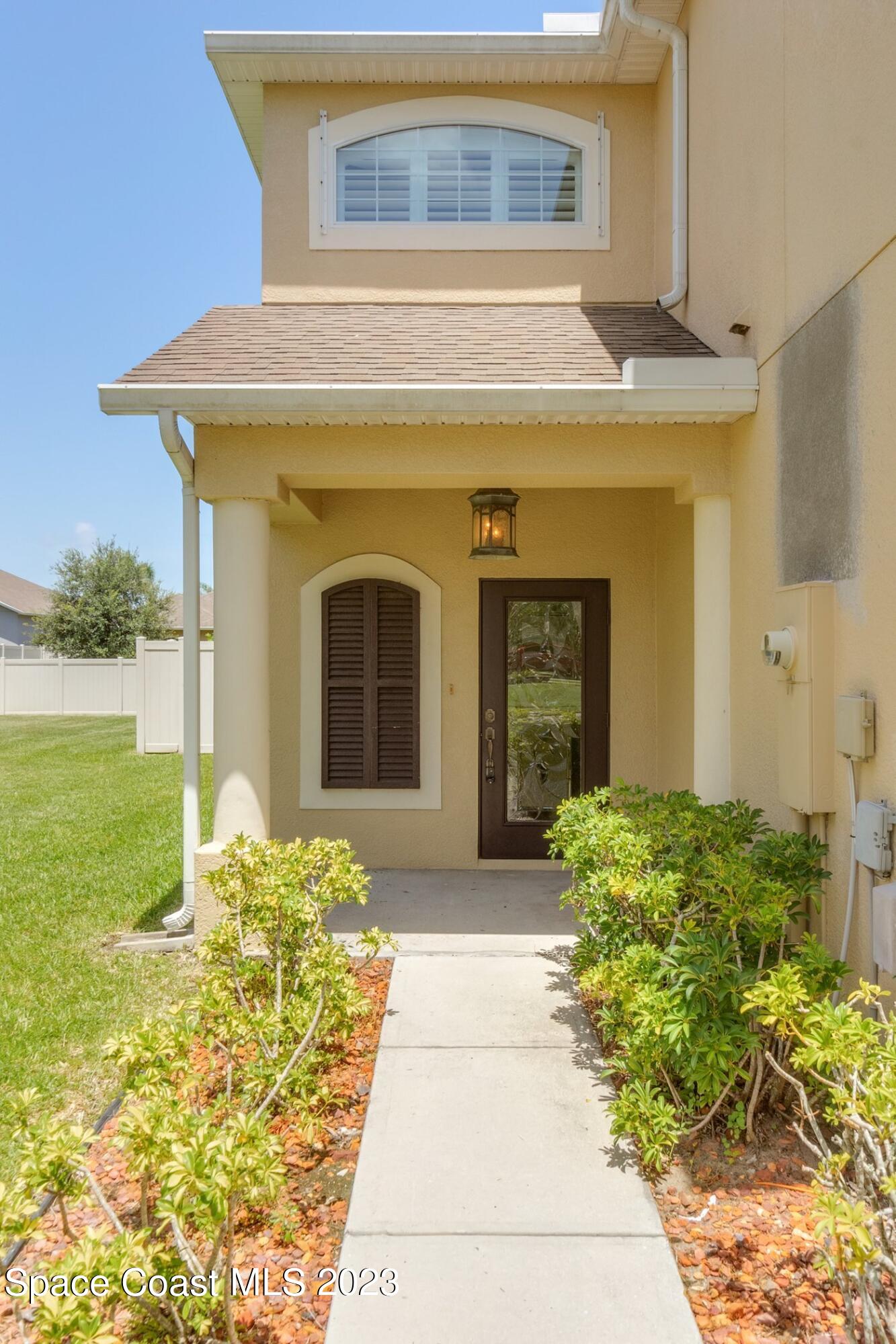 3194 Arden Circle Melbourne, FL 32934 - Photo 2 of 40 a front view of a house with garden
