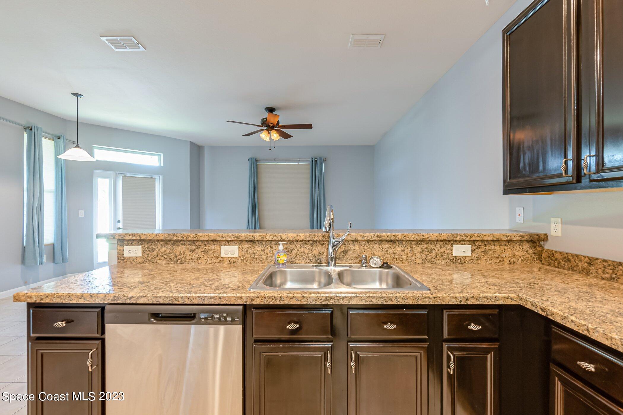 3194 Arden Circle Melbourne, FL 32934 - Photo 22 of 40 a sink with granite countertop a sink and cabinets