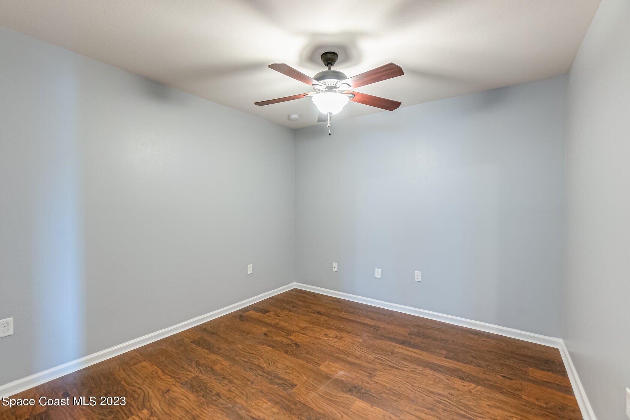 3194 Arden Circle Melbourne, FL 32934 - Photo 28 of 40 a view of an empty room with wooden floor