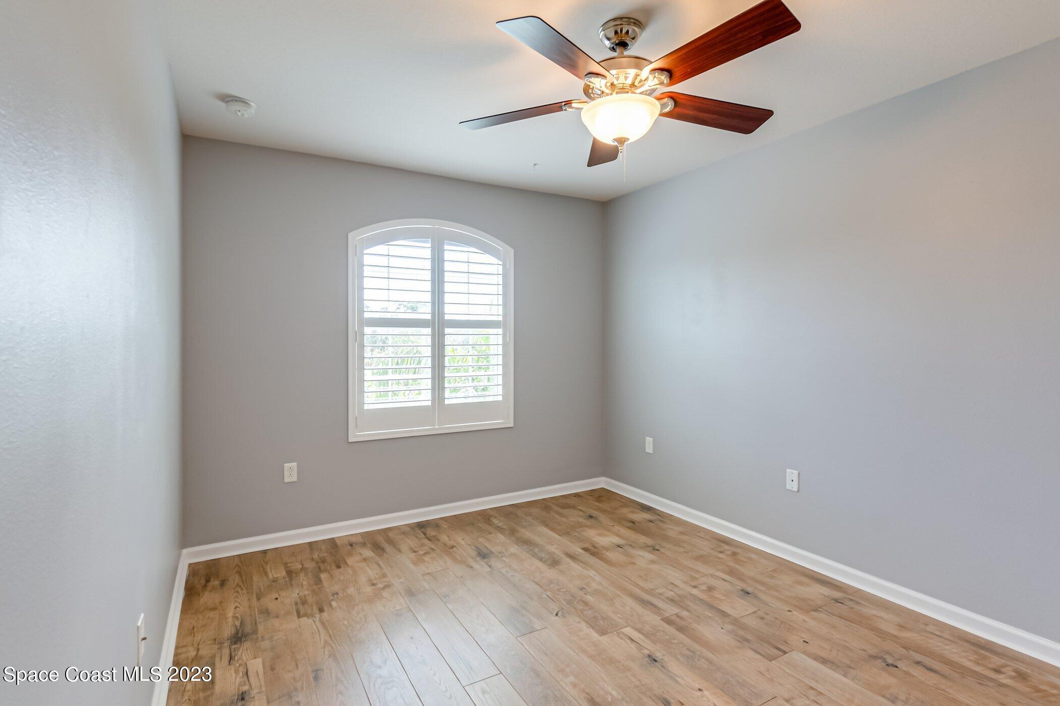 3194 Arden Circle Melbourne, FL 32934 - Photo 29 of 40 an empty room with a window and a fan