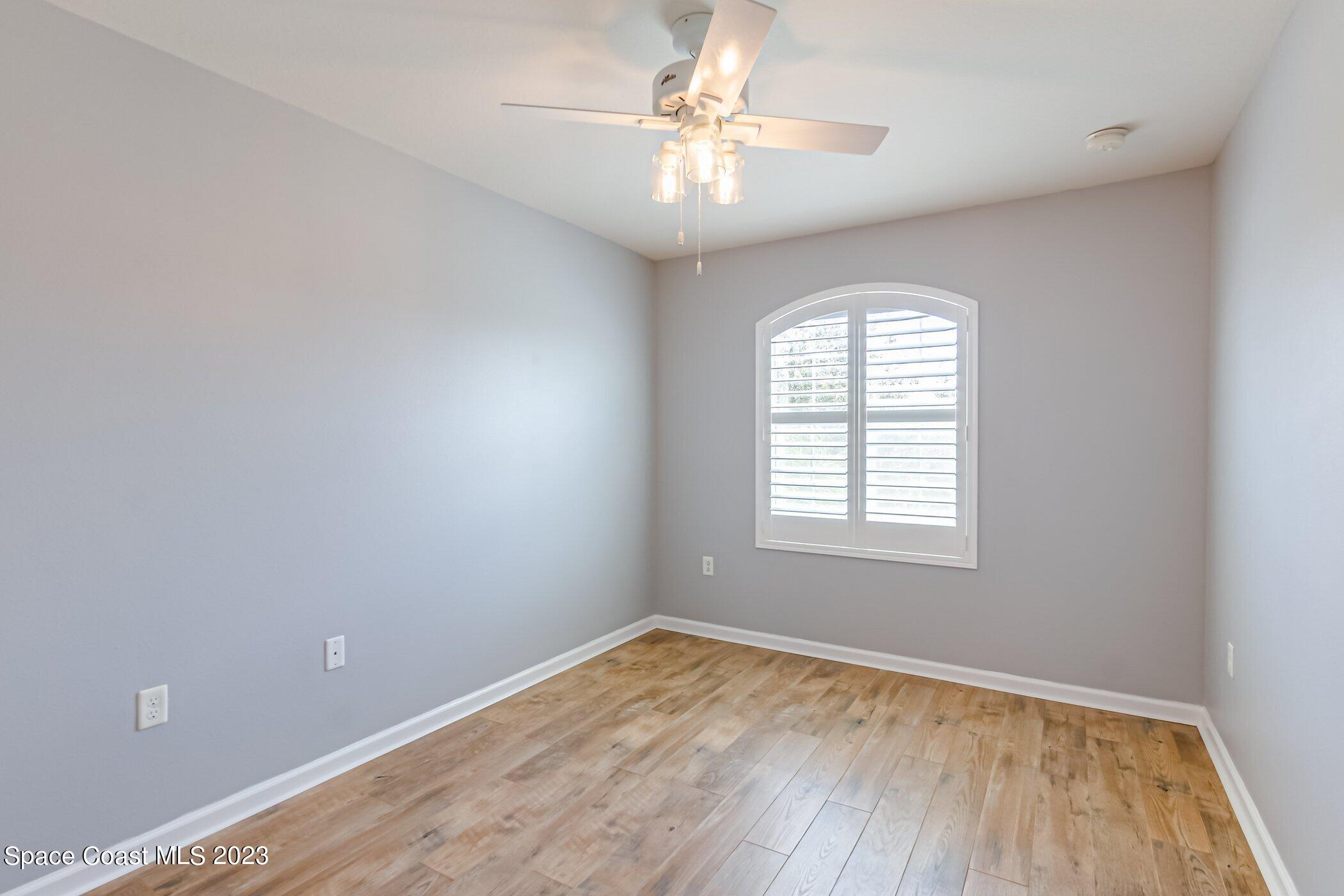 3194 Arden Circle Melbourne, FL 32934 - Photo 31 of 40 wooden floor in an empty room with a window