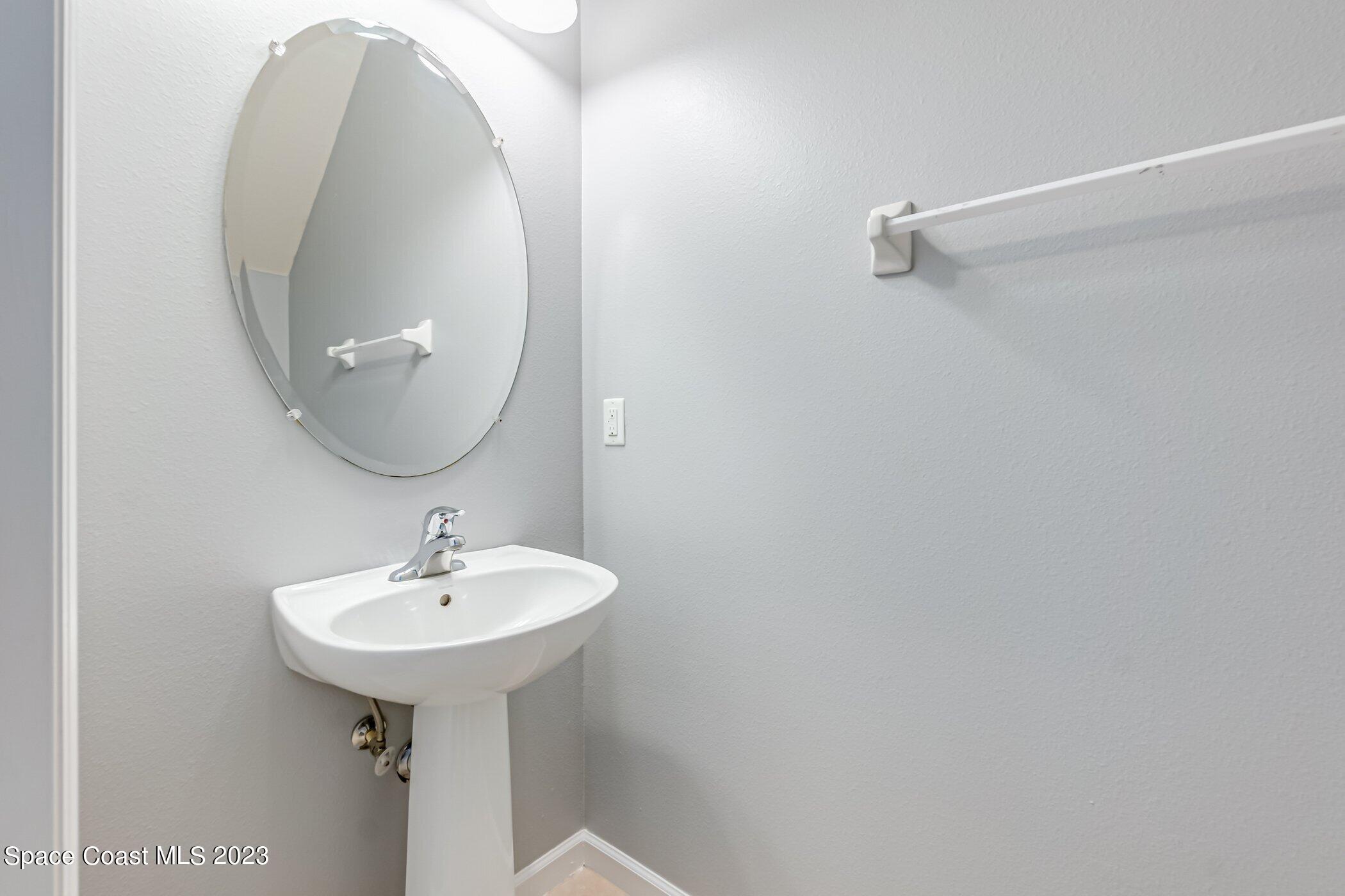 3194 Arden Circle Melbourne, FL 32934 - Photo 38 of 40 a bathroom with a sink and a mirror