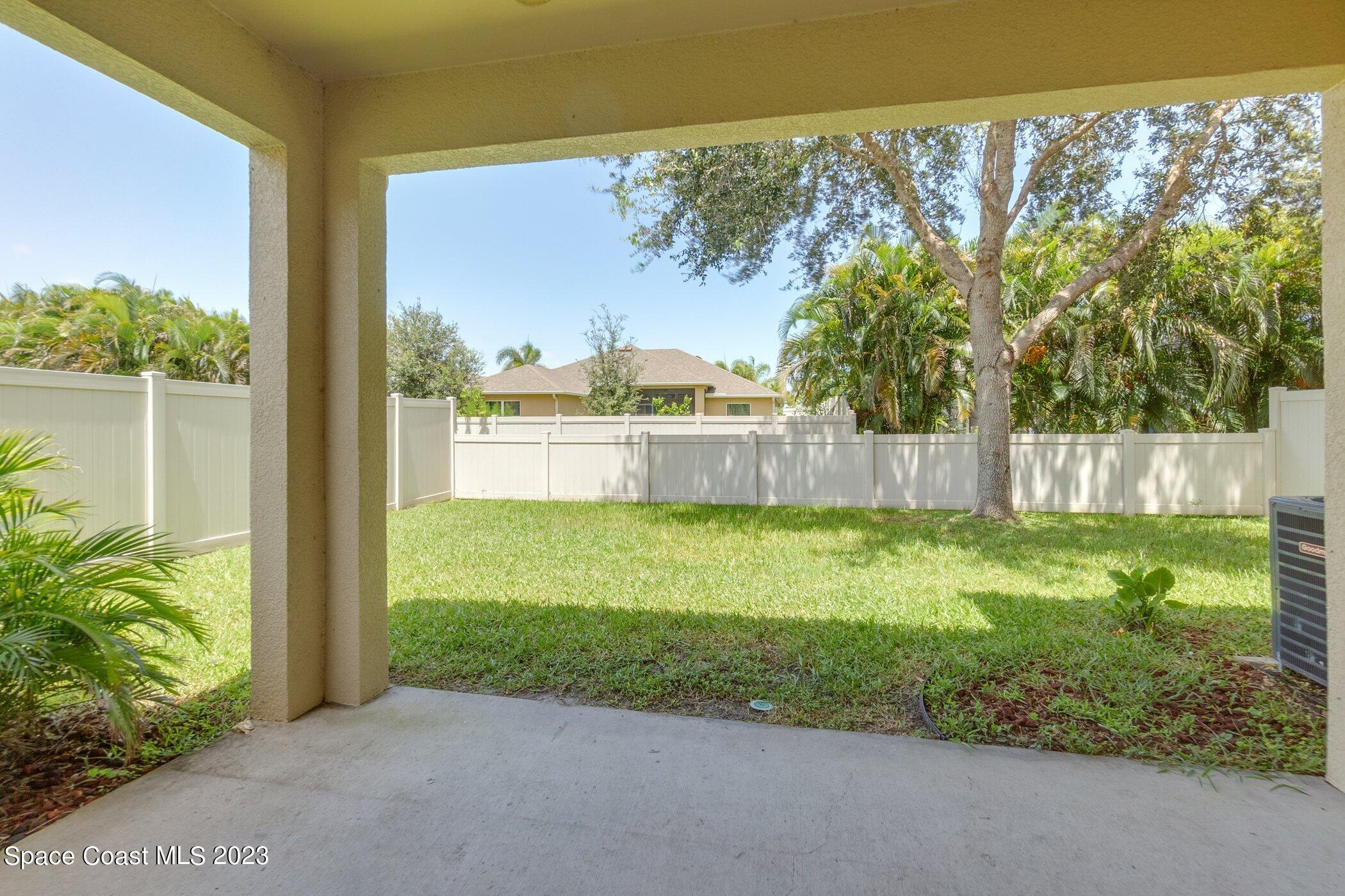 3194 Arden Circle Melbourne, FL 32934 - Photo 7 of 40 a view of a backyard with plants and lake view