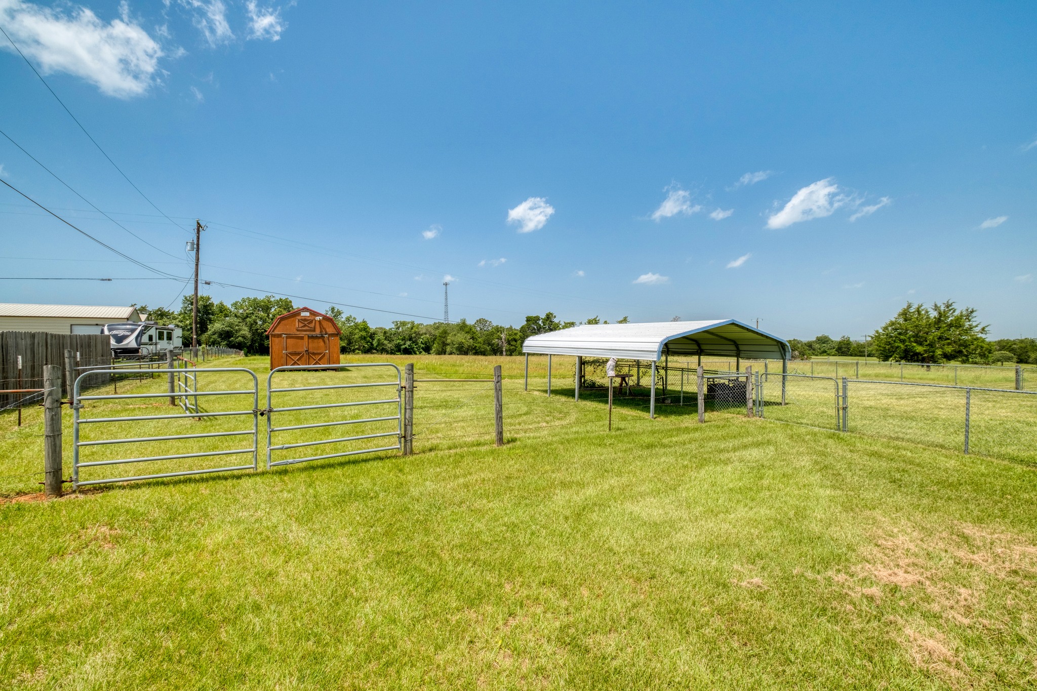 341 Brown Road McDade, TX 78650 - Photo 30 of 38 Securely fenced yard space offering ample room for outdoor activities and storage structures.