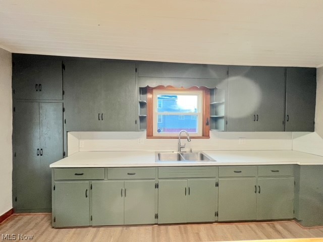 1918 Wainwright Road New Philadelphia, OH 44663 - Photo 8 of 24 Kitchen with sink, light hardwood / wood-style floors, and green cabinets
