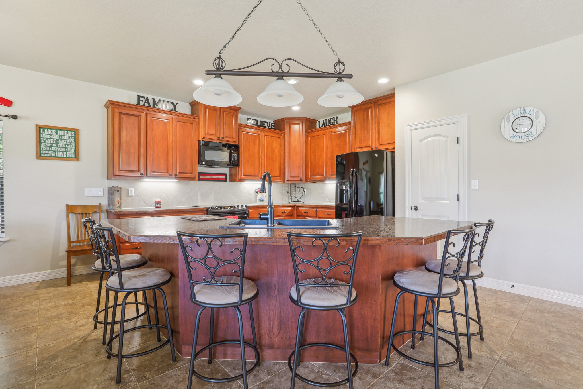 600 Augusta Circle Point Venture, TX 78645 - Photo 11 of 38 a dining room filled chandelier and wooden furniture