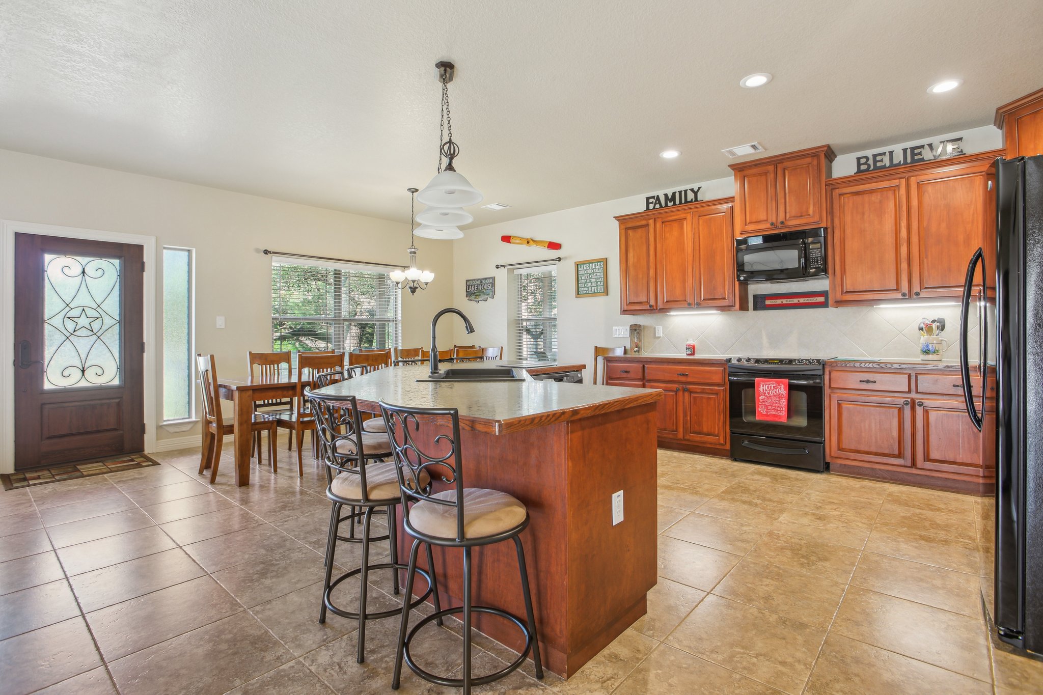 600 Augusta Circle Point Venture, TX 78645 - Photo 12 of 38 a kitchen with stainless steel appliances granite countertop a stove top oven a sink a counter top space and cabinets