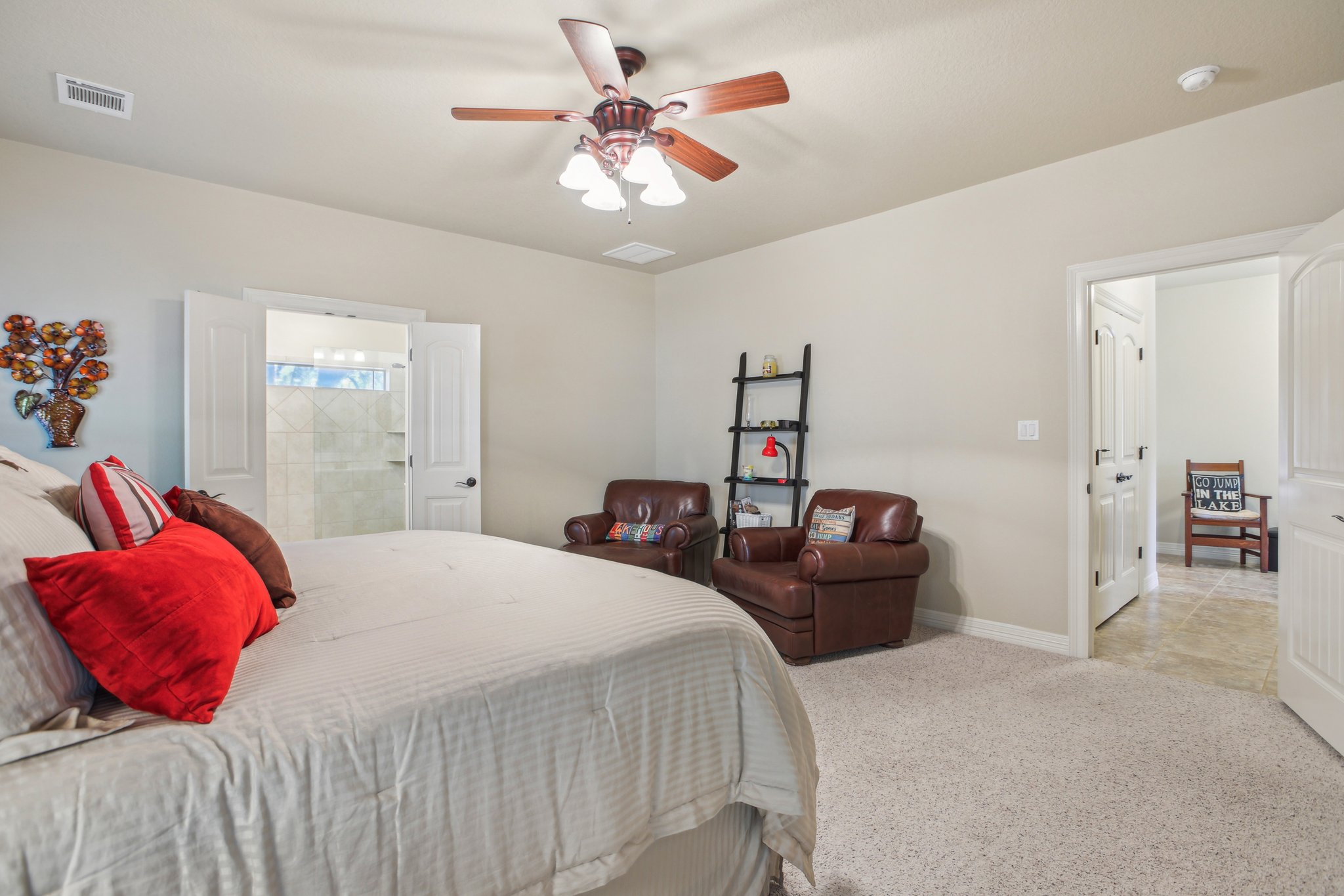 600 Augusta Circle Point Venture, TX 78645 - Photo 15 of 38 a bedroom with a bed and a chandelier