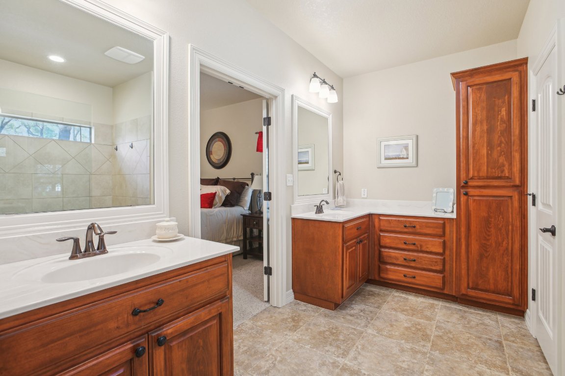 600 Augusta Circle Point Venture, TX 78645 - Photo 16 of 38 The primary bath hosts dual vanities, a walk-in closet and expansive shower