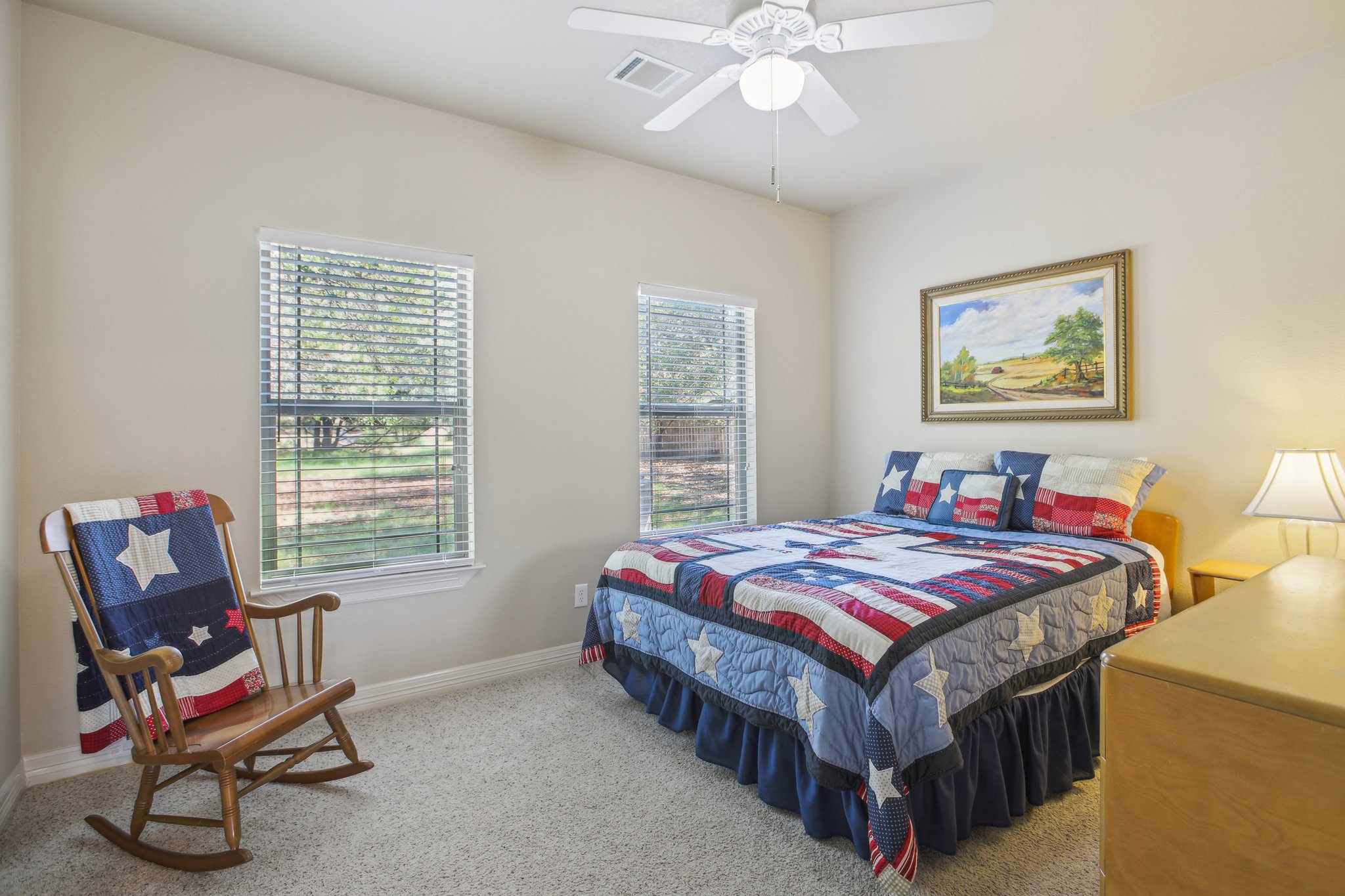 600 Augusta Circle Point Venture, TX 78645 - Photo 18 of 38 a bedroom with a bed and a chandelier