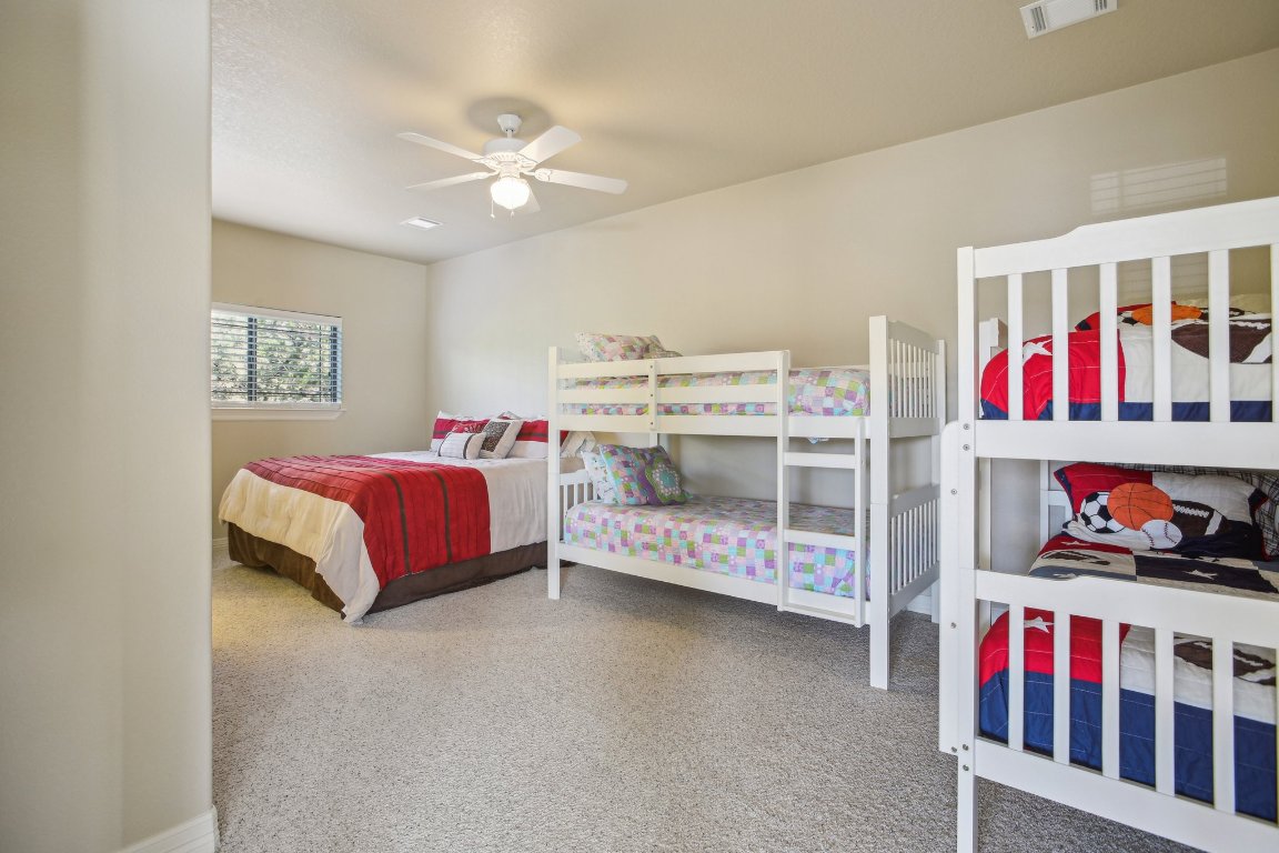 600 Augusta Circle Point Venture, TX 78645 - Photo 23 of 38 This guest bedroom is huge with two sets of bunk beds plus a large bed