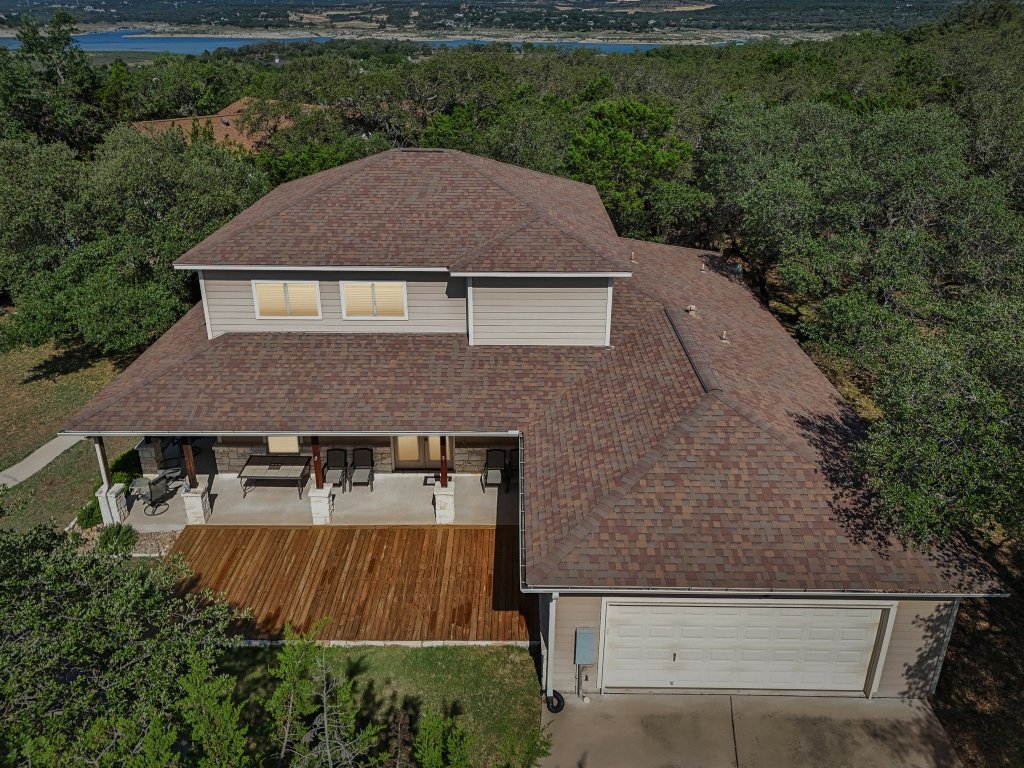 600 Augusta Circle Point Venture, TX 78645 - Photo 4 of 38 The side-entry garage, notice the large deck, in addition to the covered porch
