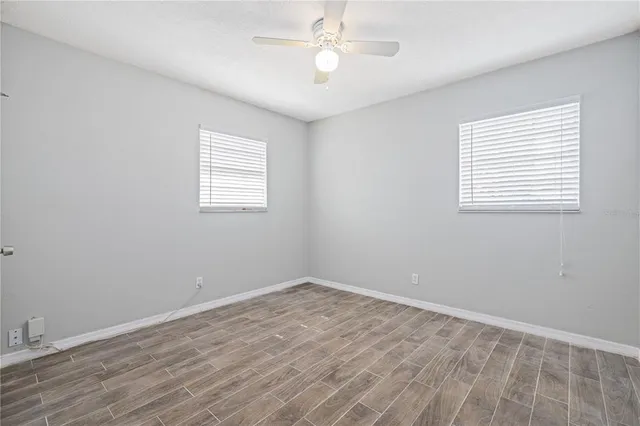 wooden floor in an empty room with a window