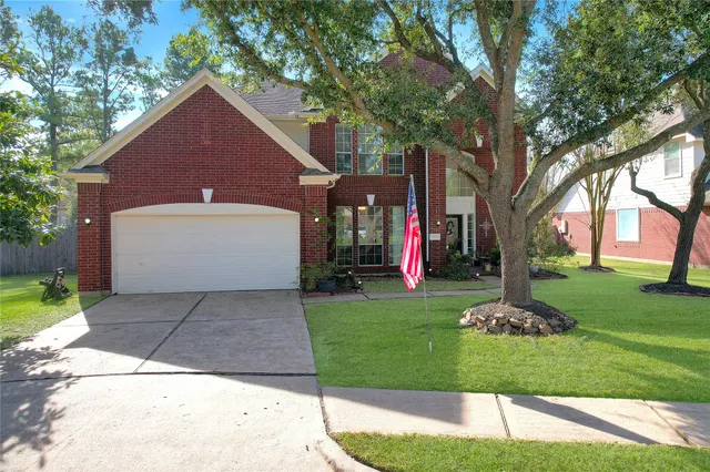 a front view of house with a yard and trees