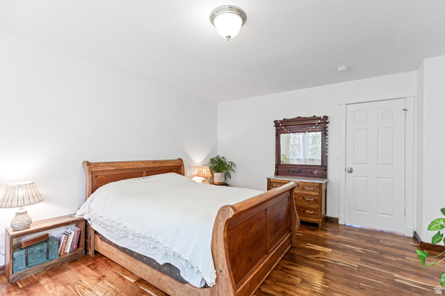 814 Mountain Road Logan, UT 84321 - Photo 11 of 42 Room featuring wood-finish flooring, a white paneled door, and a flush mount ceiling light fixture