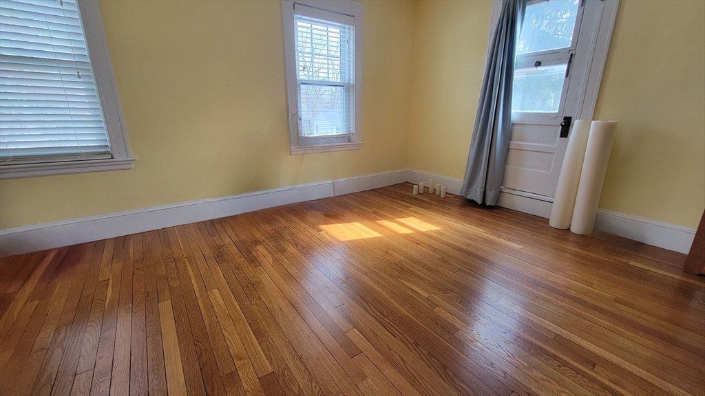 31 Plymouth Road Needham, MA 02492 - Photo 12 of 22 a view of an empty room with wooden floor and a window
