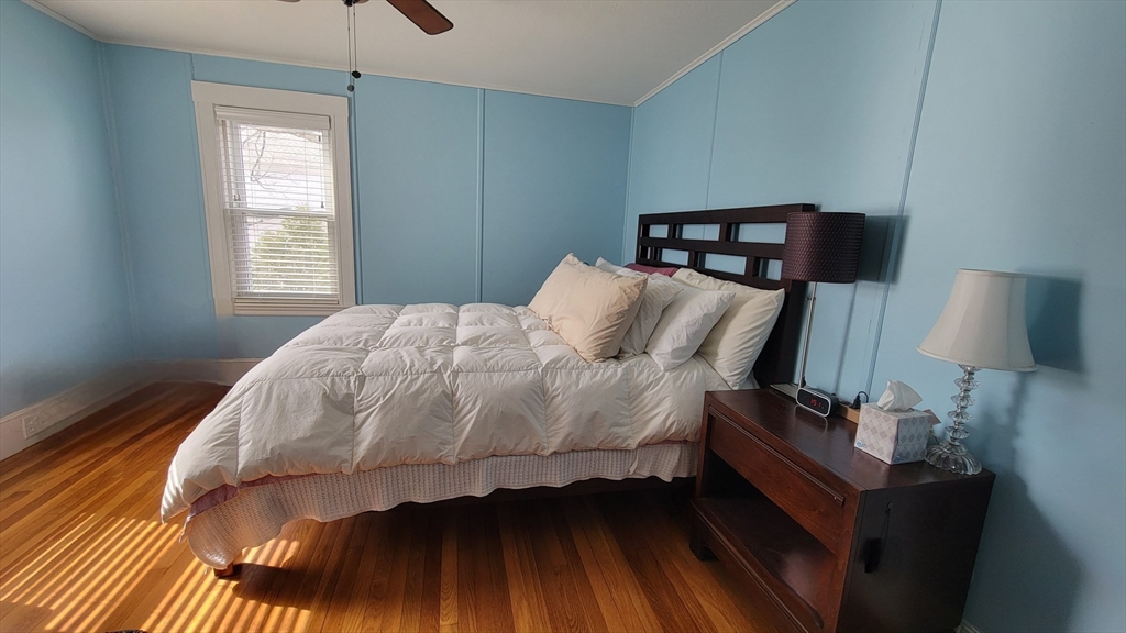 31 Plymouth Road Needham, MA 02492 - Photo 14 of 22 a bedroom with a bed and a lamp