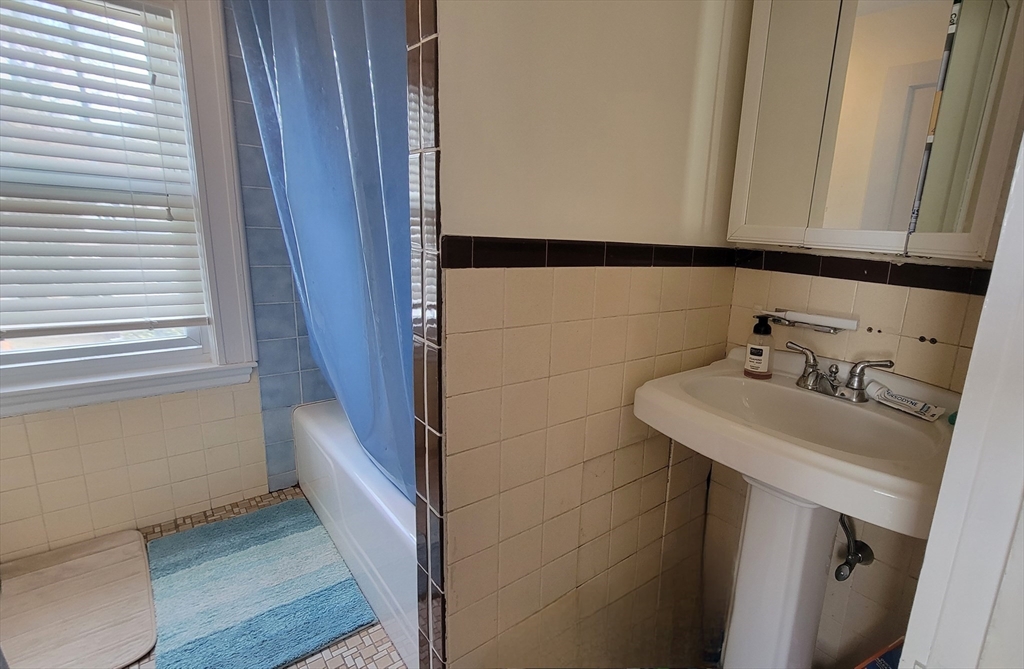 31 Plymouth Road Needham, MA 02492 - Photo 17 of 22 a bathroom with a sink and a mirror