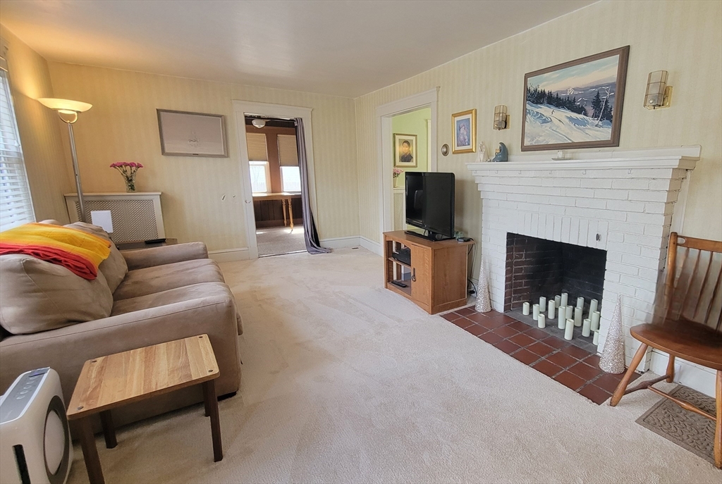 31 Plymouth Road Needham, MA 02492 - Photo 3 of 22 a living room with furniture and a fireplace
