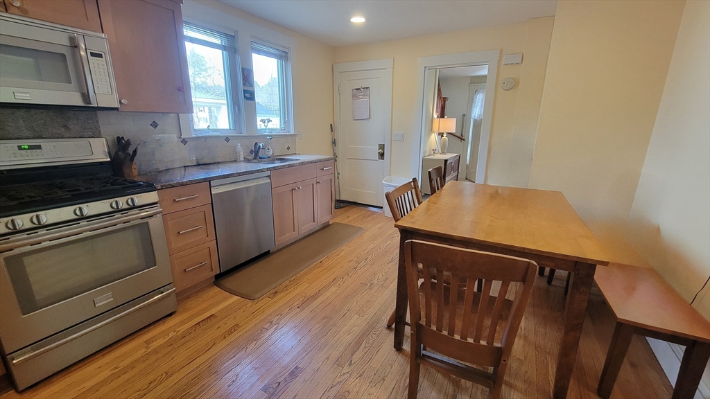 31 Plymouth Road Needham, MA 02492 - Photo 6 of 22 a kitchen with wooden floors and white appliances