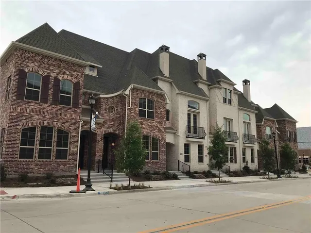 a view of a brick building next to a street