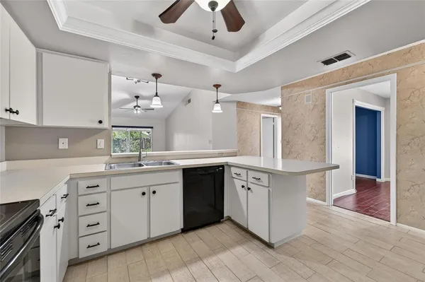a spacious kitchen with stainless steel appliances granite countertop a lot of counter space and wooden floors
