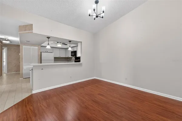 a view of a kitchen with wooden floor and a kitchen