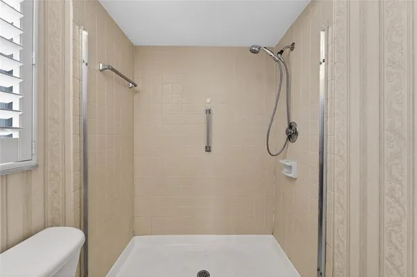 a bathroom with a shower and toilet