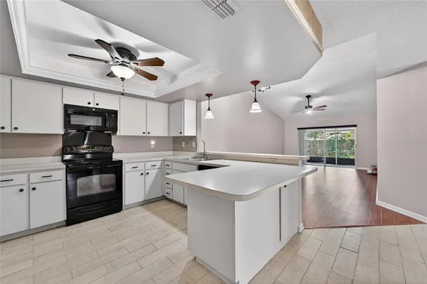 a kitchen with a stove sink and refrigerator