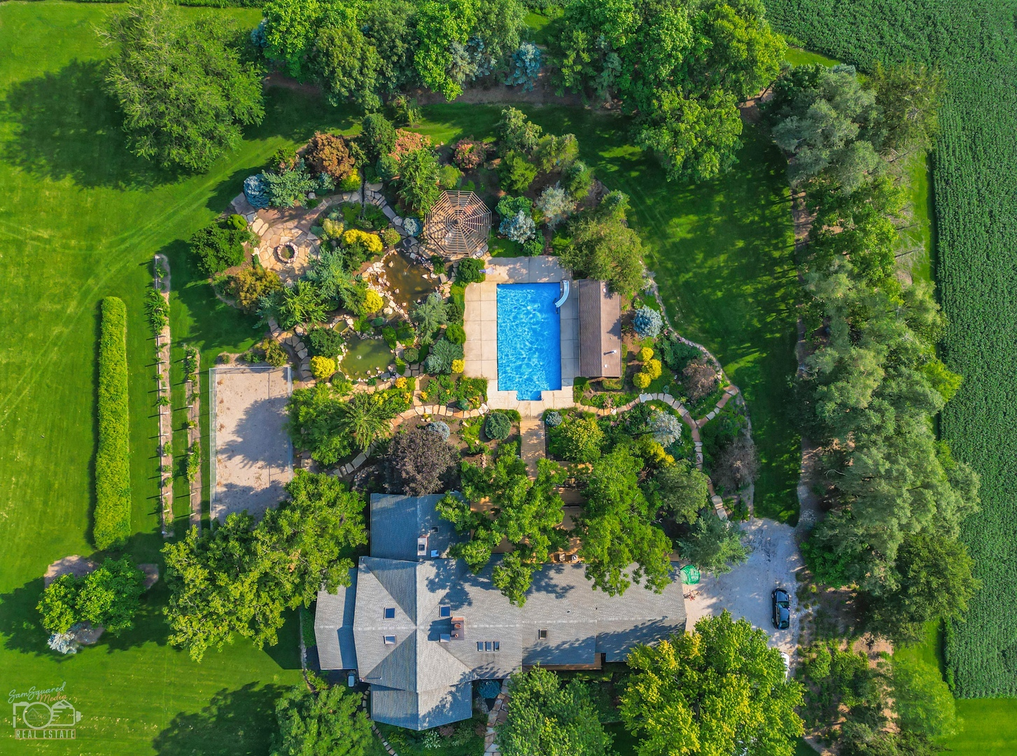 an aerial view of a house with a yard