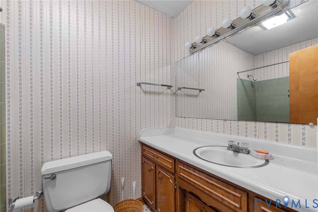 24925 Smith Grove Road Petersburg, VA 23803 - Photo 11 of 19 Bathroom featuring vanity, a shower, and wallpaper