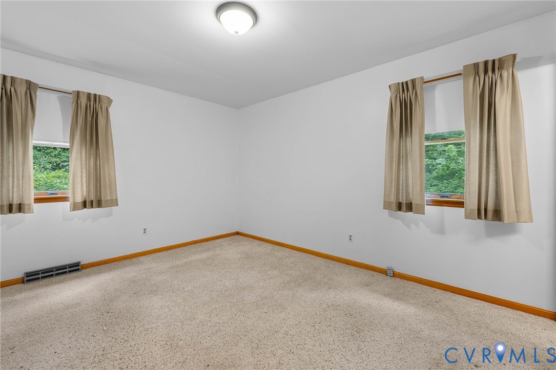 24925 Smith Grove Road Petersburg, VA 23803 - Photo 12 of 19 Carpeted empty room featuring baseboards