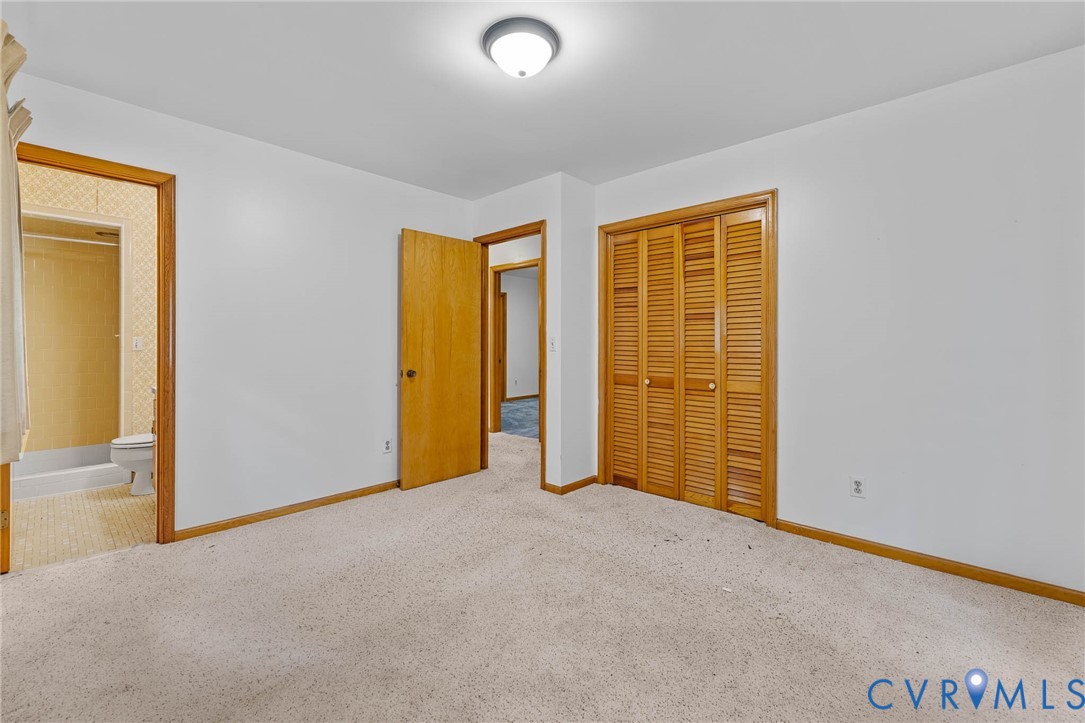 24925 Smith Grove Road Petersburg, VA 23803 - Photo 13 of 19 Unfurnished bedroom with carpet, a closet, and con